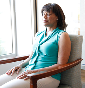 Woman relaxing in chair with eyes closed.