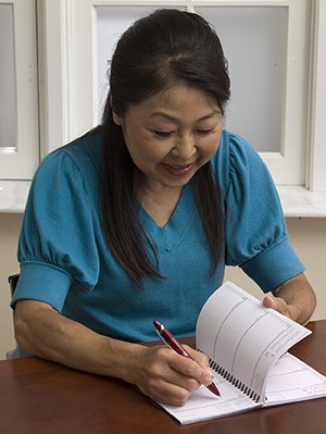 Woman writing in journal.