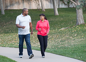 Man and woman outdoors, walking.