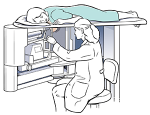 Woman lying on stereotactic breast biopsy machine, which technician is operating.